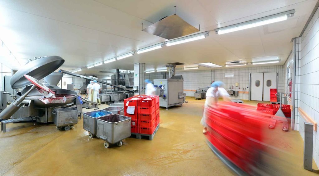 Sanitation workers clean equipment to meet food industry sanitation standards.